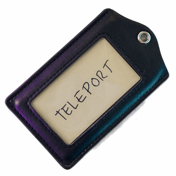 a leather tag with a piece of paper with "Teleport"